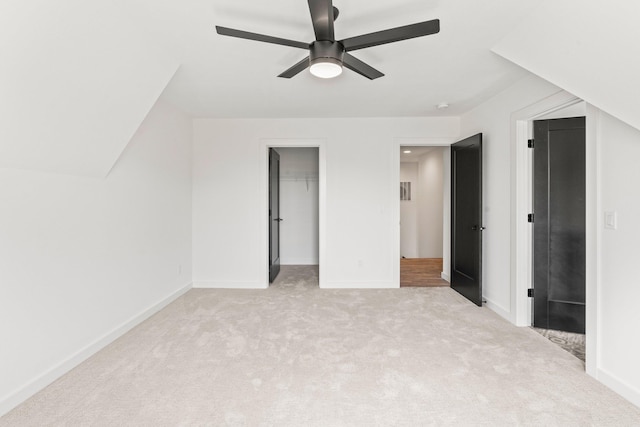 interior space featuring ceiling fan and light colored carpet