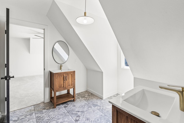 bathroom featuring lofted ceiling, tile patterned floors, and vanity