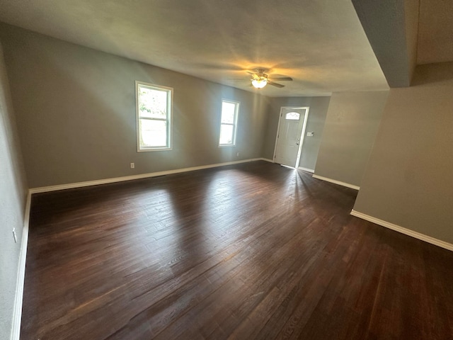 spare room featuring dark hardwood / wood-style floors and ceiling fan