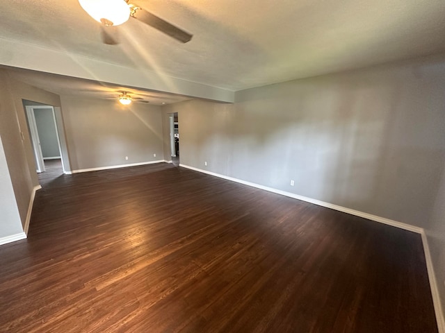 empty room featuring ceiling fan and dark hardwood / wood-style flooring