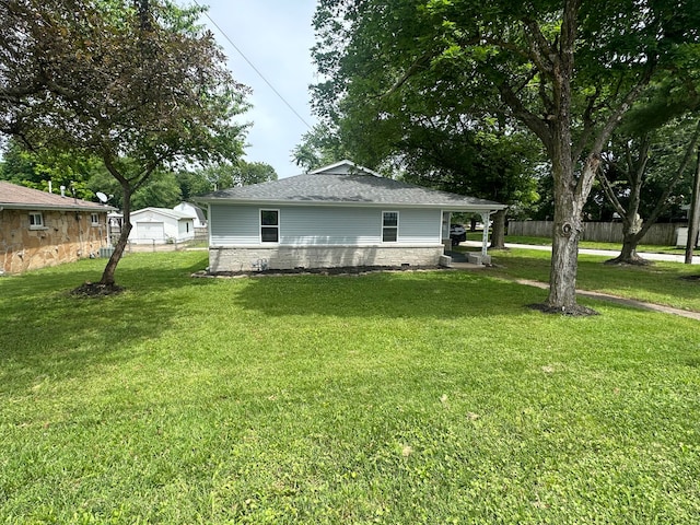 view of side of home featuring a garage, a yard, and an outdoor structure