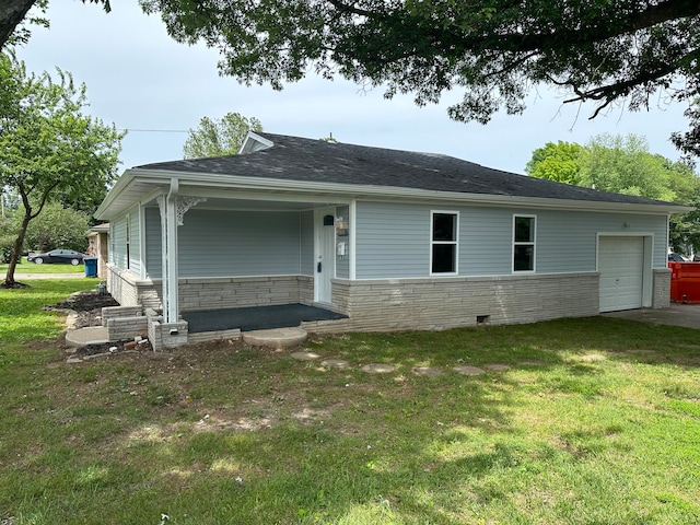 view of front of home with a garage and a front lawn