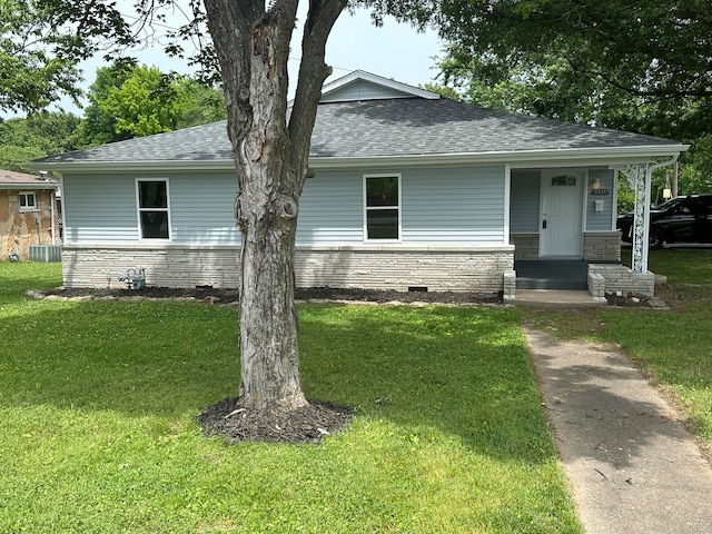 view of front facade with a front yard and central AC