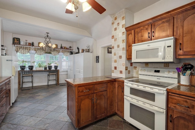 kitchen featuring decorative backsplash, white appliances, kitchen peninsula, and ceiling fan with notable chandelier