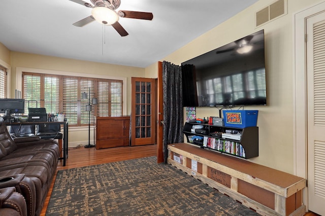 living room featuring ceiling fan and hardwood / wood-style floors