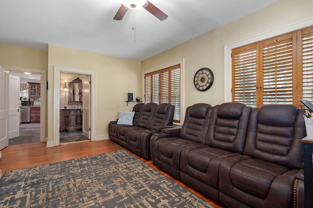 living room featuring dark hardwood / wood-style floors, ceiling fan, and plenty of natural light