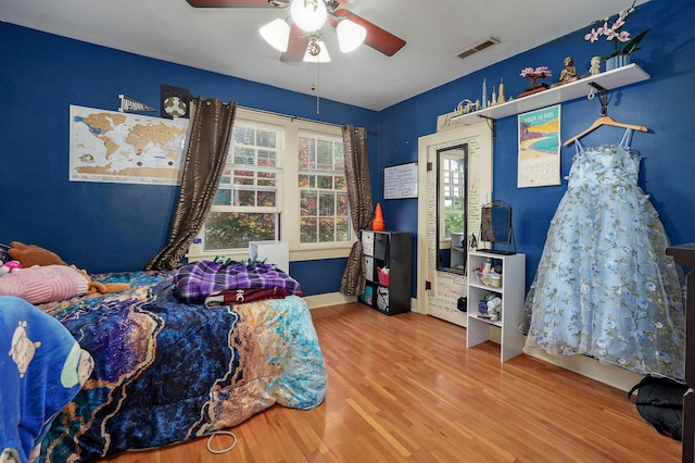 bedroom featuring hardwood / wood-style flooring and ceiling fan