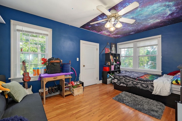 bedroom with ceiling fan and light hardwood / wood-style floors