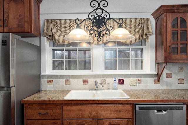 kitchen featuring a healthy amount of sunlight, decorative backsplash, sink, and stainless steel appliances