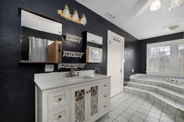 bathroom with tile patterned flooring, vanity, and ceiling fan