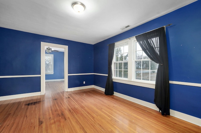 unfurnished room featuring ceiling fan and wood-type flooring