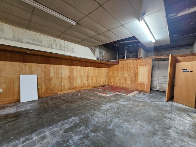 basement featuring wood walls