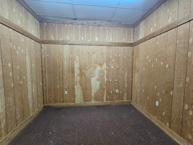 unfurnished room featuring wood walls