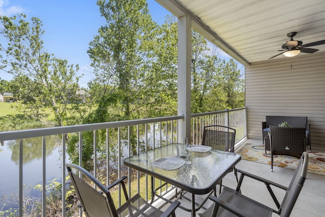 balcony featuring a water view and ceiling fan