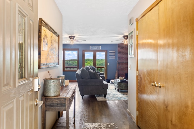 hallway with a textured ceiling and dark wood-type flooring