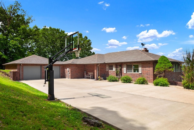 ranch-style home featuring a garage, brick siding, a front yard, and concrete driveway