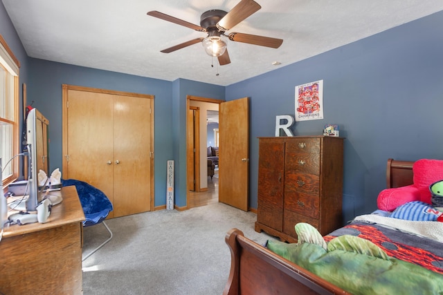 bedroom featuring a ceiling fan, a closet, and carpet