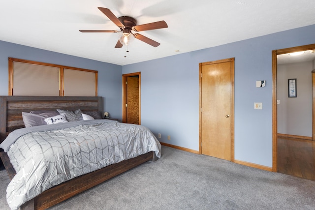 carpeted bedroom with a ceiling fan and baseboards