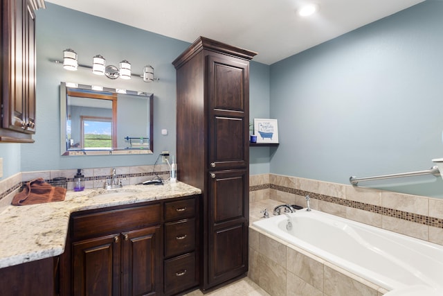 full bathroom with recessed lighting, a garden tub, and vanity