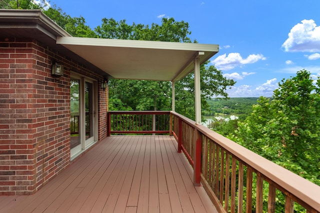 wooden terrace featuring a water view