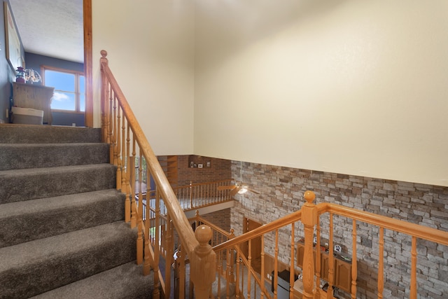 staircase featuring ceiling fan
