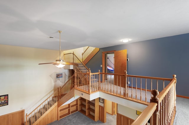 stairway featuring carpet flooring and ceiling fan