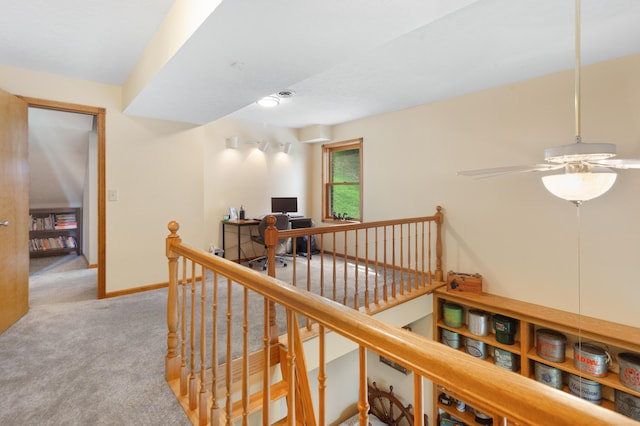 hallway with baseboards, carpet flooring, and an upstairs landing