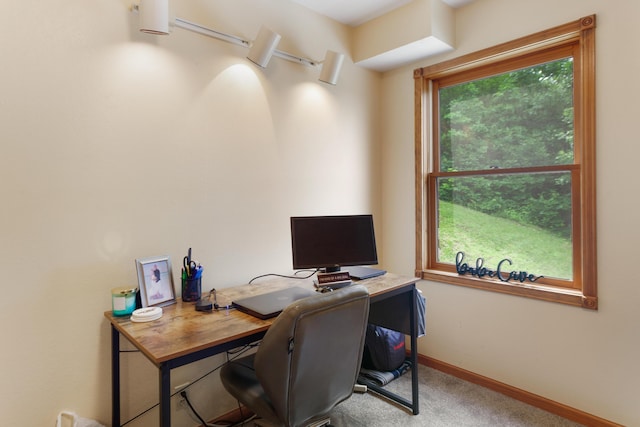 carpeted office space featuring baseboards