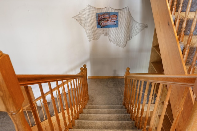 stairs featuring carpet floors and baseboards