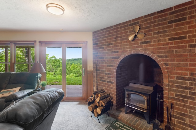 carpeted living room with a textured ceiling and a wood stove