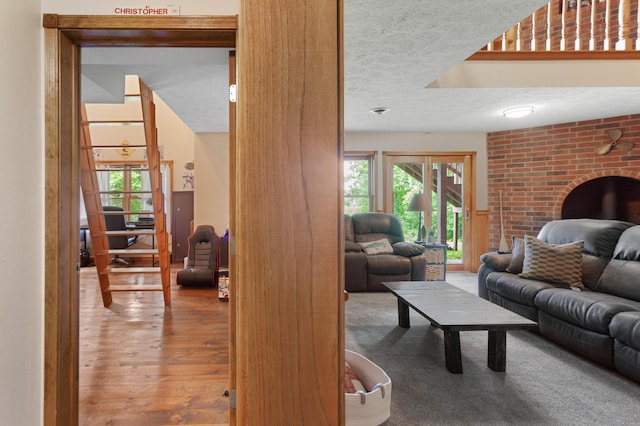 living area with wood finished floors and a textured ceiling