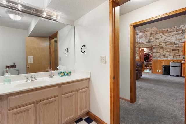 bathroom with a textured ceiling and vanity