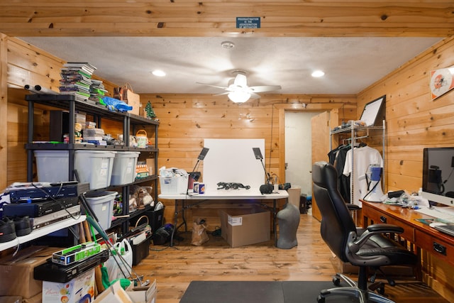 office featuring a ceiling fan, wood finished floors, wooden walls, and recessed lighting