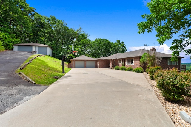 ranch-style house with a chimney, brick siding, a garage, and a front yard