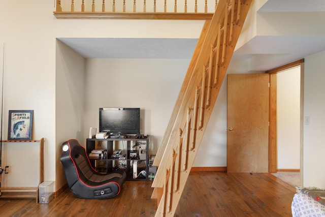 staircase featuring wood-type flooring and baseboards