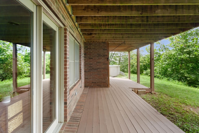 wooden deck featuring a yard