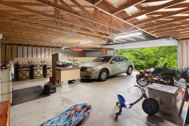 garage featuring a garage door opener and a carport