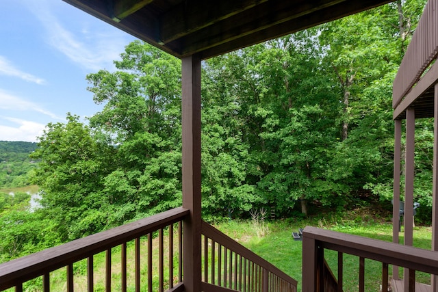 wooden terrace featuring a lawn
