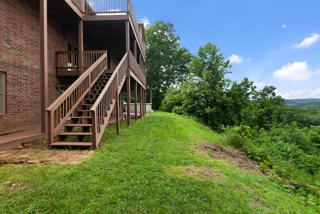 view of yard with stairway and a deck