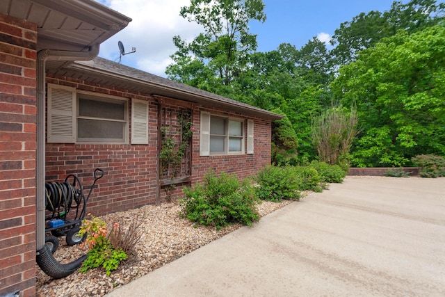 view of side of property with brick siding