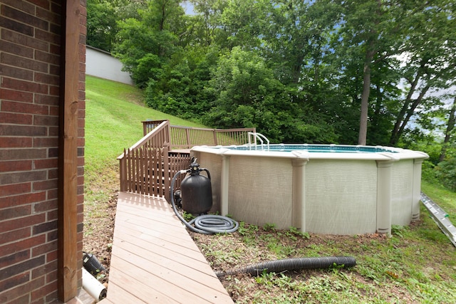 wooden terrace with an outdoor pool