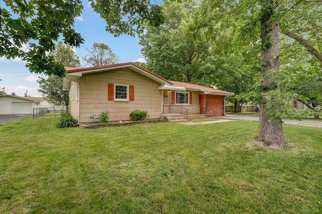 single story home with a garage and a front lawn