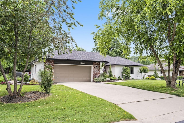 ranch-style house featuring a front yard and a garage