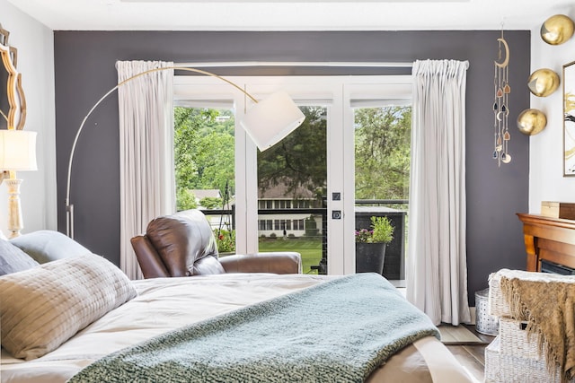 bedroom featuring access to outside and light hardwood / wood-style floors