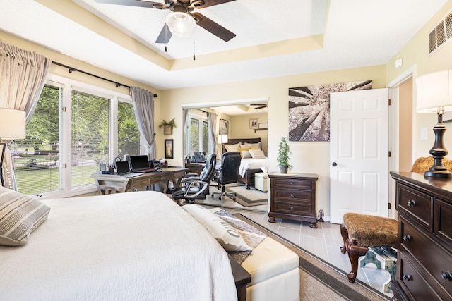 bedroom featuring a tray ceiling and ceiling fan