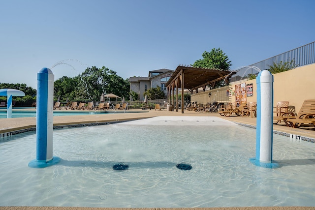 view of swimming pool featuring pool water feature and a patio area