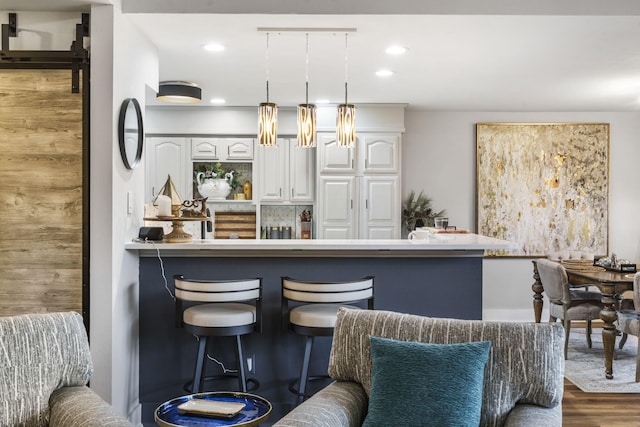 bar with pendant lighting, white cabinetry, and dark wood-type flooring