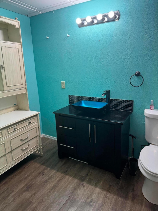 bathroom with vanity, wood-type flooring, and toilet