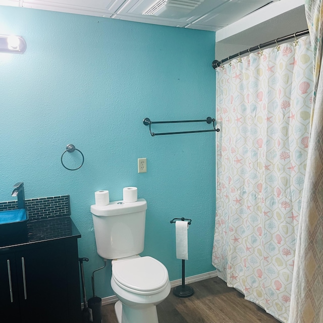 bathroom with vanity, wood-type flooring, and toilet