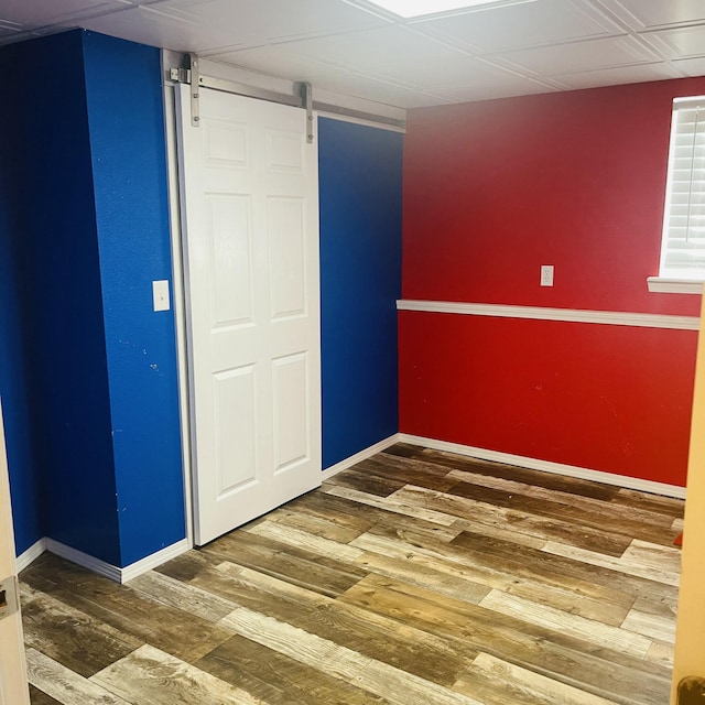 interior space featuring hardwood / wood-style flooring and a barn door